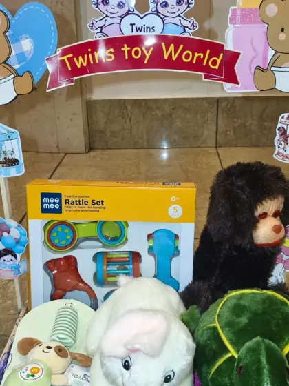 The 'Twins Toy World' carriage, filled with a variety of soft toys and rattle sets for both babies to share and enjoy.