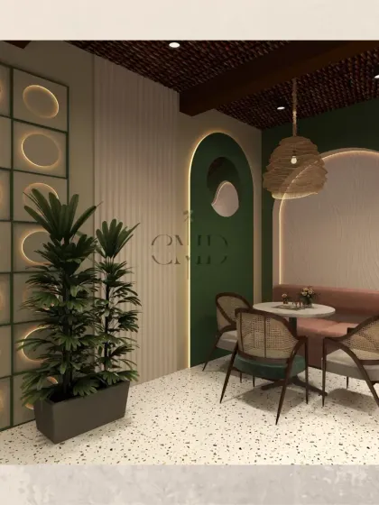 A cozy corner in the cafe featuring a plush banquette, intimate table setting, and a decorative backlit wall panel. Potted plants add a touch of greenery, reinforcing the natural, earthy theme of the design.