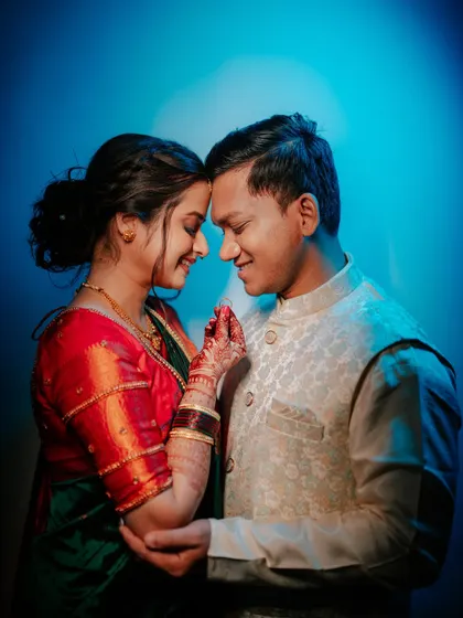 An intimate portrait of the couple with dramatic blue backlighting.