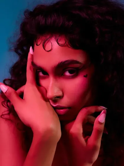 A close-up beauty shot with dramatic red and blue lighting. This technique is used to create a futuristic and edgy vibe, perfect for avant-garde makeup stories.