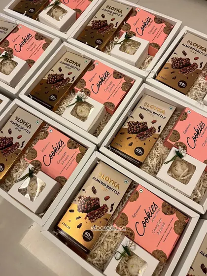 Great gifts don't always need a huge budget. This image showcases our budget-friendly Diwali hampers filled with delicious cookies and almond brittle, proving that thoughtful gifting can be accessible.