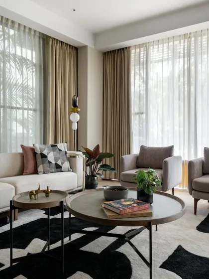 In the living room of Villa 93, we created a sanctuary of calm with a neutral color palette and abundant natural light. The design marries modern furniture with a bold, graphic rug, creating a space that is both sophisticated for entertaining and comfortable for quiet family moments.