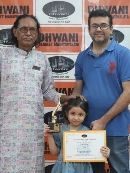 A student with her father and guru, celebrating her win.