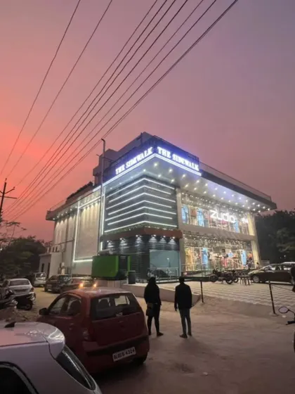 Here is the completed 'The Sidewalk' commercial building in Rajnagar at dusk. The facade lighting I designed creates a striking presence, highlighting the modern architecture and making it a landmark in the area.