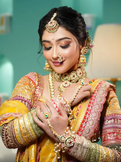 A close-up on the details. This image showcases the beautiful hand jewellery (hathphool) and the soft, shimmering eye makeup of our Maharashtrian bride.