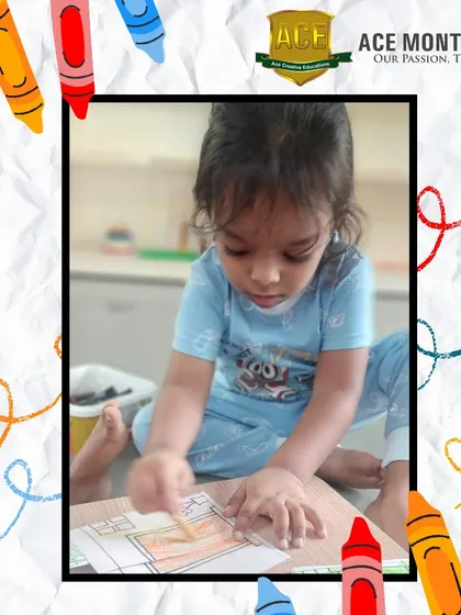 Little Vishnu is hard at work on his coloring project. Even at a young age, activities like this help develop the hand strength and coordination needed for future writing skills.