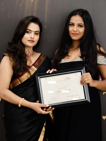 Receiving my professional makeup artist certificate from my mentor, Lakshmi Shetty. Her academy is where I built my foundational skills.