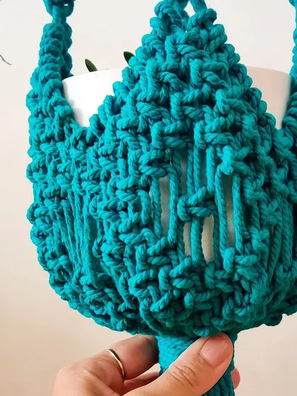 Another view of the beautiful teal plant hanger.