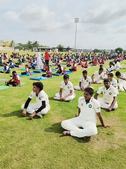 Our students participate in a large-scale yoga session on the field. This practice is integral to our curriculum for improving focus and preventing injuries.