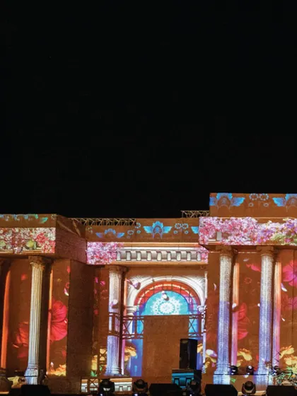 Another view of the projection mapping on the grand stage, with vibrant floral patterns washing over the columns and arches. This fusion of ancient architecture and modern technology is a hallmark of my work.
