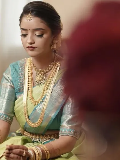 A beautifully composed shot of the bride. The minimal makeup ensures that the focus remains on her, the stunning saree, and the sacredness of the moment.