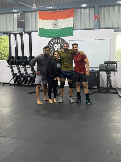 A smaller group photo under the Indian flag at our box. We are proud of our community and the strength we build together.