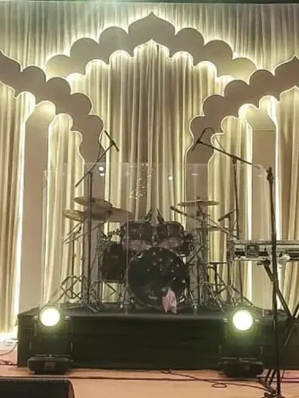 A clean and elegant stage backdrop we created for a musical performance. The repeating, backlit arches provide a sophisticated and visually interesting setting that enhances the performers without overpowering them.