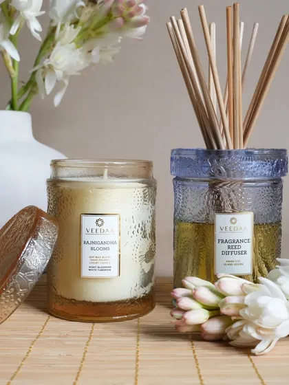 The intoxicating floral scents of Rajnigandha Blooms and Fresh Mogra. Here they are shown in our hand-cut glass candles and a reed diffuser, bringing the fragrance of a lush garden indoors.