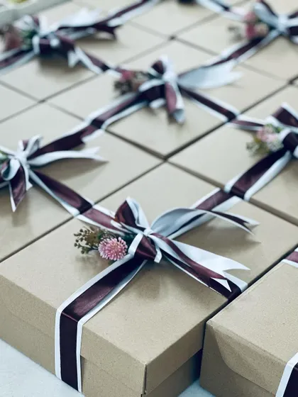A side view of the corporate gift boxes, showing the delicate floral accents on each one.