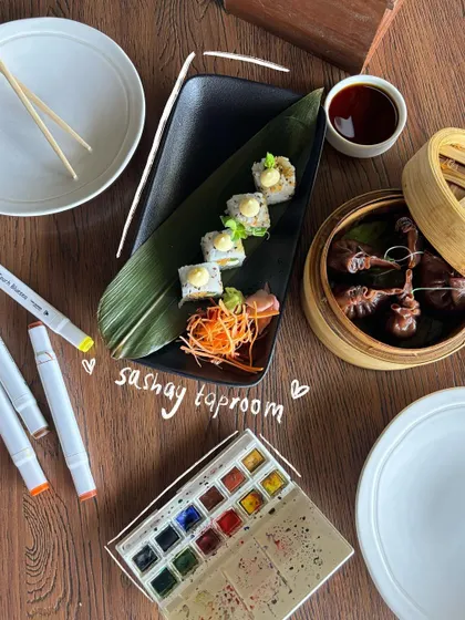 An artful food flatlay, complete with my watercolor set. The doodles highlight the sushi and dim sum.