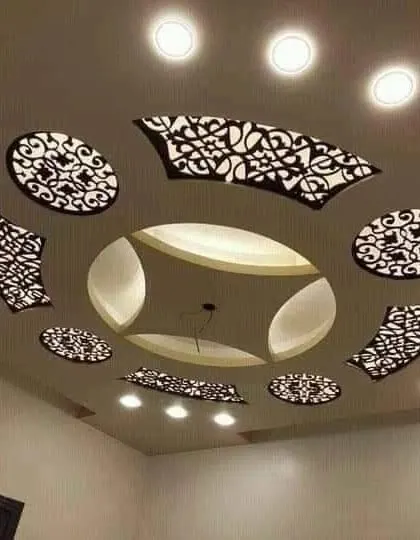 This ceiling uses floating jali panels to create a stunning decorative effect. The light shines through the intricate patterns, casting beautiful shadows and adding a layer of artistry to the room.