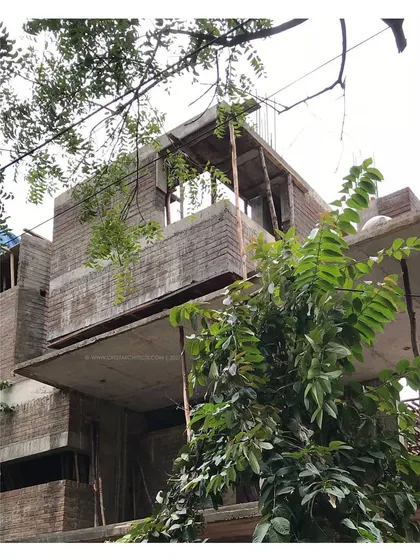 'Residence 97' in its early stages, with the brickwork and concrete slabs defining the cantilevered volumes.
