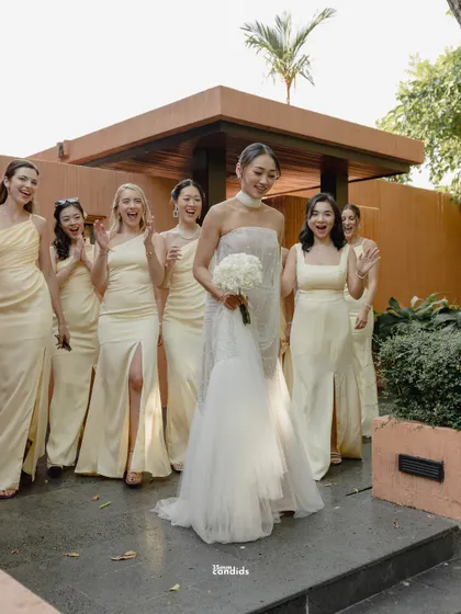 Before she walked the aisle, she walked into their arms. A beautiful shot of the bride's first look with her bridesmaids, their happy reactions making the moment perfect.