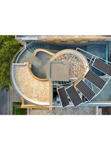 The plan of the People Tree House is derived from a golden rectangle, with a central 'trunk' housing the circulation core. The design is a direct response to the site's ecology, with solar panels and rainwater harvesting systems fully integrated into its form.