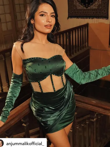 A full-length view of the custom green satin dress I designed for the song 'Koka'. The draping and corset detailing were carefully crafted to create a striking silhouette.