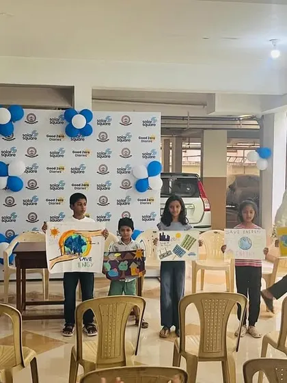 Young artists from Shivaprakruthi Society showcasing their beautiful solar-themed drawings during the inauguration event.