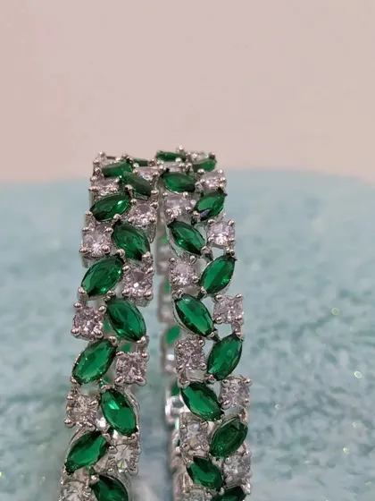 Another view of the leaf-design emerald AD bangles.