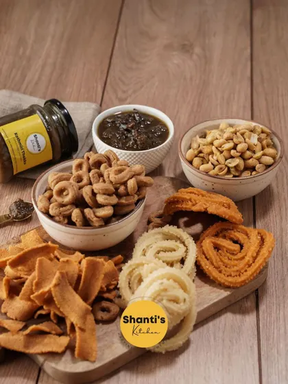 I love seeing my snacks arranged on a board like this. It shows the wonderful variety, from different kinds of murukku and ribbon pakoda to my special homemade chutney, all ready for a family get-together.