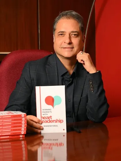 A confident seated portrait of the author at his desk with a stack of his books. This is a powerful image that signifies accomplishment and expertise.