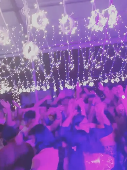 The purple lighting and fairy lights created a magical atmosphere for this wedding reception.