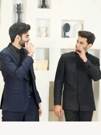 A showcase of two distinct styles for a formal event. On the left, a navy suit with an embroidered lapel, and on the right, my signature black textured Jodhpuri suit.
