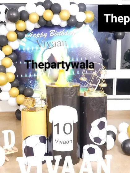 Another angle of the football-themed party, showing the complete setup with balloon columns and personalized name blocks.