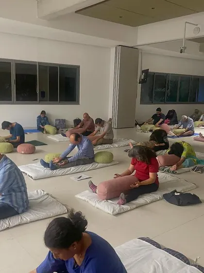 Another view of the mindful movement session at a community event. The focus is on gentle stretching and connecting with the body, accessible to everyone regardless of their fitness level.