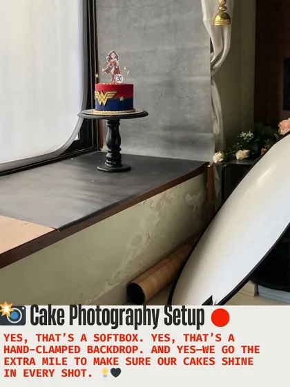 Our Wonder Woman cake sits beside the photography backdrop, showing the setup used to photograph the finished birthday design.