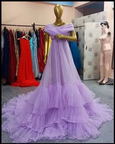 This lavender A-line gown features a full, tiered tulle skirt and an off-the-shoulder neckline. It's a beautiful pastel option for a soft and romantic photoshoot.