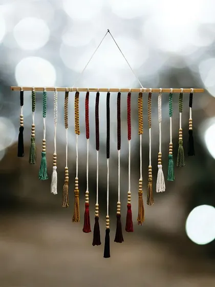 A beautifully shot photo of my colorful tassel wall hanging. This piece is perfect for adding a bohemian charm to any space.