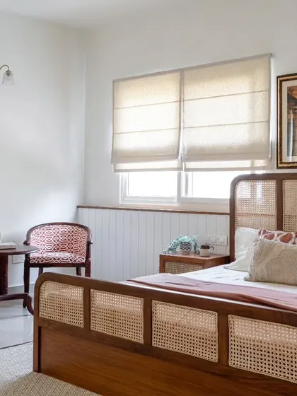 Another angle of the parent's guest room, showing the plush upholstery of the antique chairs and the warm, woody ambiance created by the furniture and paneling.