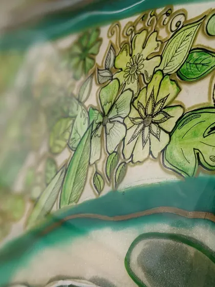 A close-up of the details in one of my green geode artworks. I love combining the smooth flow of resin with hand-doodled floral patterns, adding a layer of personal touch and intricacy.