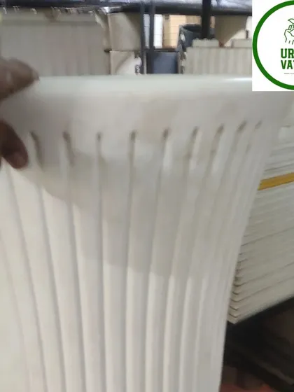 A tall, fluted white plastic pot.