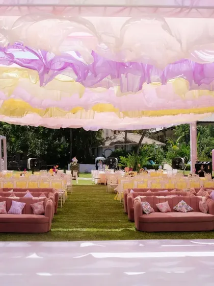 A dreamy overhead view of the 'Pastel Mela' Mehendi setup, with flowing lilac and yellow drapes creating a whimsical canopy.