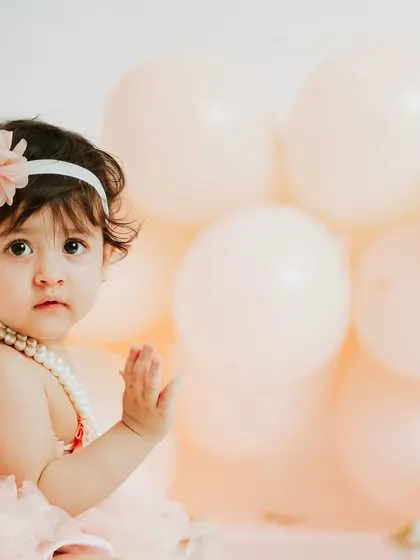 A sweet wave to the camera. The simplicity of the setup allows her personality to be the star of the show.