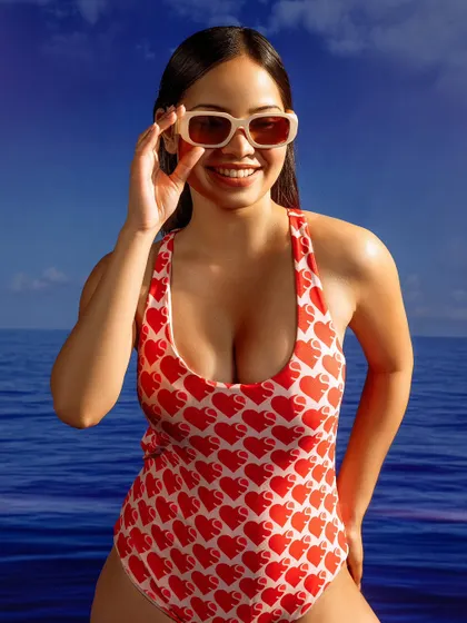 A classic summer-themed commercial shot. The model's smile and the bright, cheerful styling are perfect for a beauty or swimwear campaign.