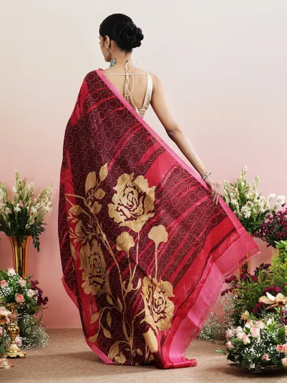 The back view of the maroon floral saree, showcasing the dramatic pallu print.