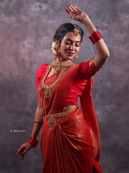 This portrait captures a graceful, dance-like pose. Studio lighting allows me to freeze the motion and highlight the flow of the fabric and the subject's form.