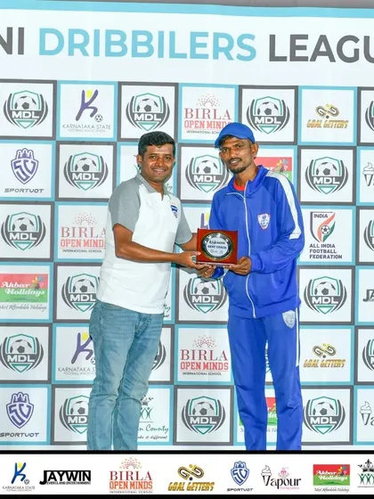 Recognition for our dedicated staff. One of our coaches receives the Best Coach award at the Mini Dribblers League Tournament, a testament to the quality of mentorship at our academy.