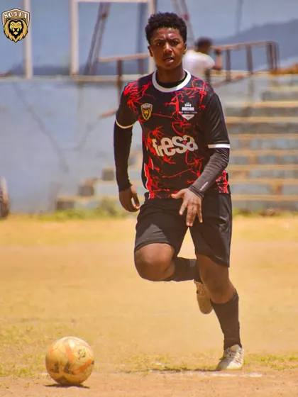 A player in our black and red kit running with the ball during the U17 Youth Championship.