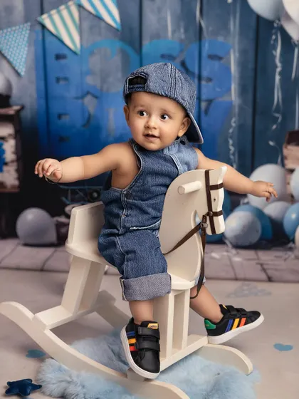 A ride on the rocking horse for this denim-clad cutie. This is another fun shot from my 'Boss Baby' inspired collection, showing a more playful and casual side of the theme.