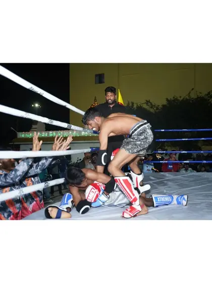 A dominant position in a Muay Thai match. Our fighter controls his opponent on the ground after a successful sweep.