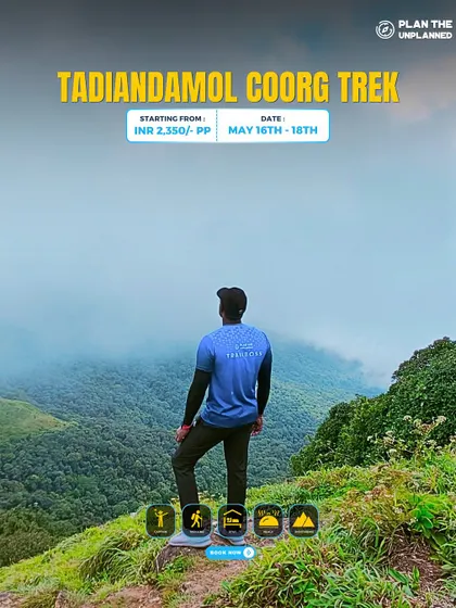 A trekker looks out over the misty mountains on the Tadiandol trek.
