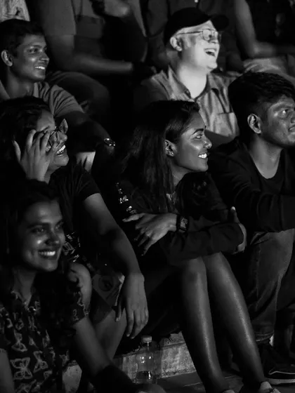 A black and white shot of the audience at IIM Trichy roaring with laughter during Samay Raina's performance. This is the result we aim for.